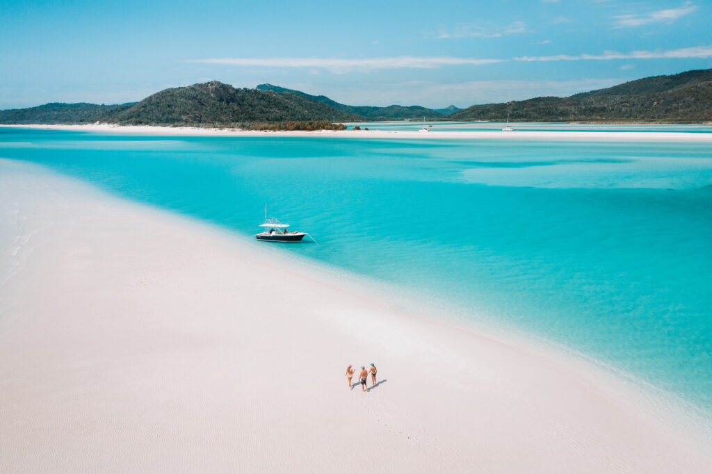 Walking on sand bar near Whitehaven Beach Hill Inlet | Queensland holiday ideas for students