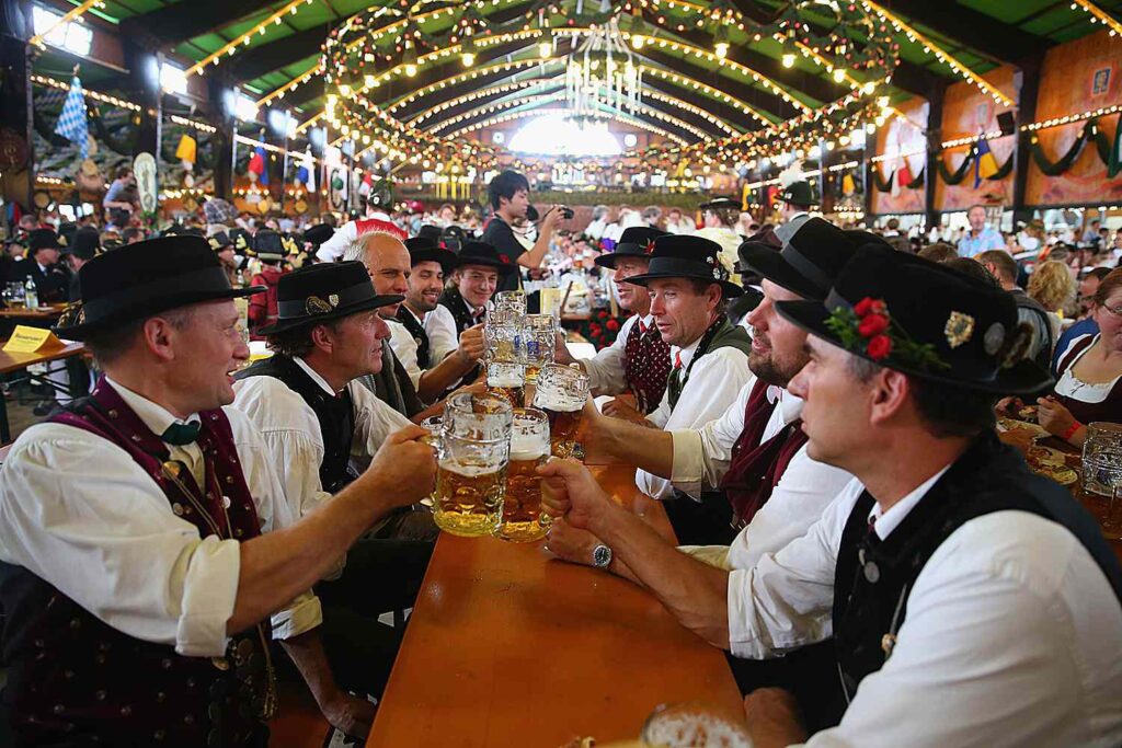 Picture of men sitting around the table drinking beer at the Oktoberfest in Germany