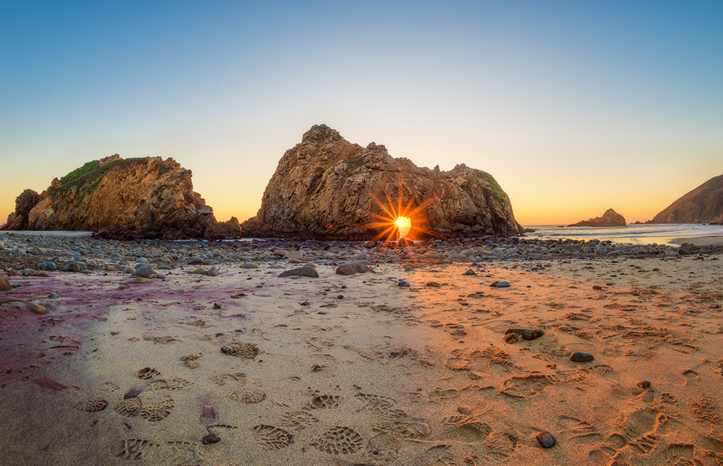 Sunrise peaking through the rocks on the Pfeiffer Beach.