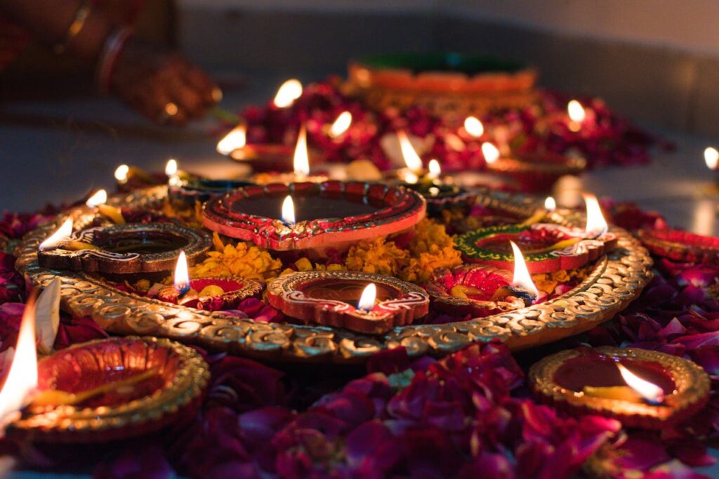 picture of food and candles on the floor during a night celebration of Diwali