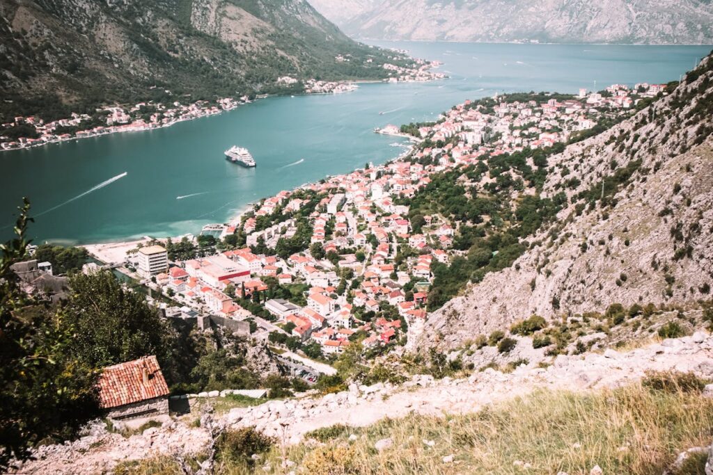 Picture of the bay of Kotor, with a yacht in the water. 