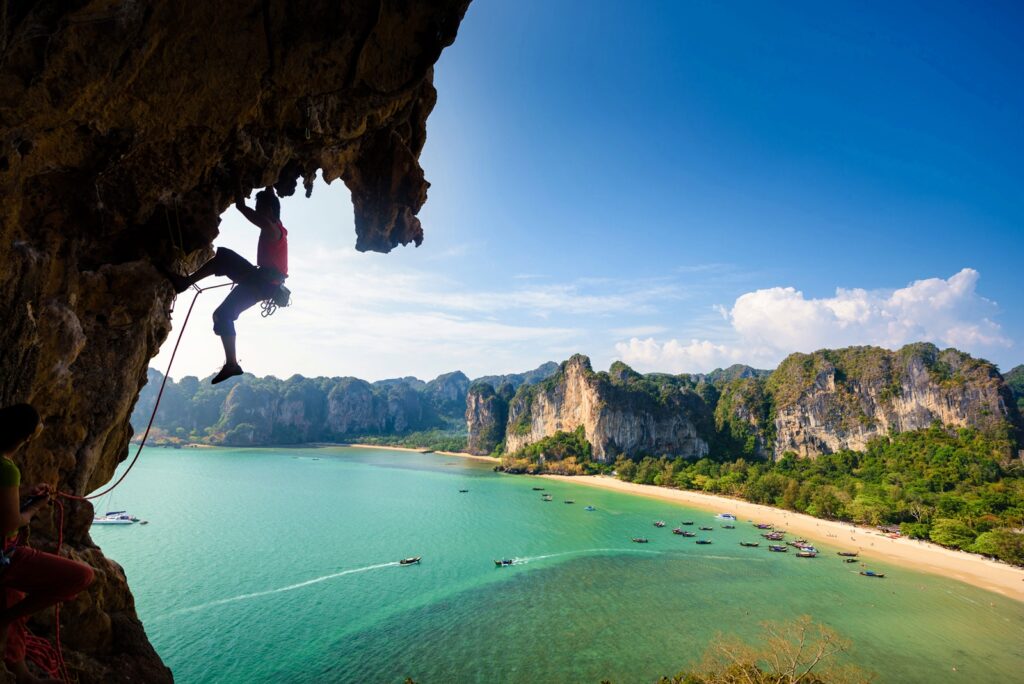 A picture of the Railay Beach on a sunny day, with local boats on the beach.