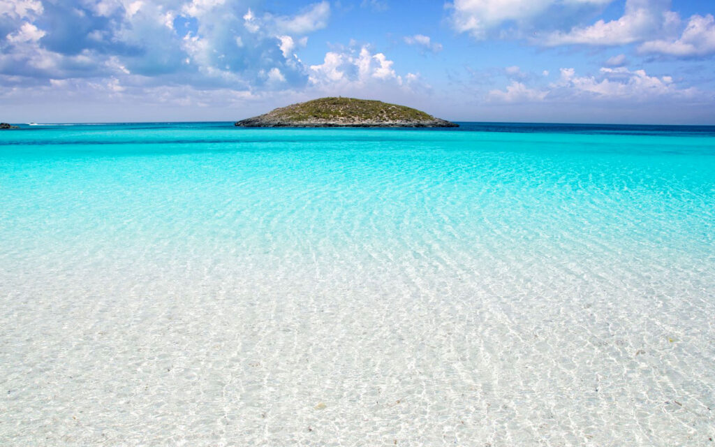 Picture of Ses Illetes beach with a small island in the ocean, Spain.