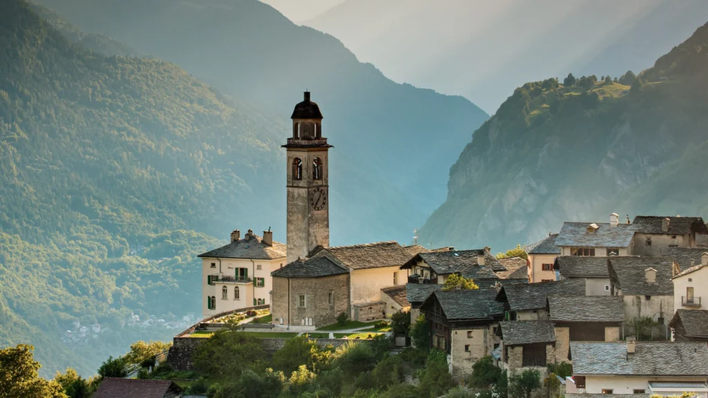 Picture of a small town called Soglio in Switzerland with a church bell rising above the surrounding buildings